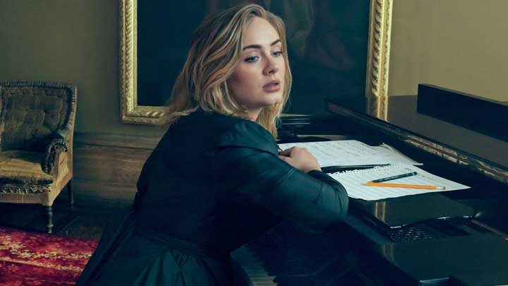 Adele reviews handwritten lyrics under sunlight, revealing sharp reasoning and lyrical thought.