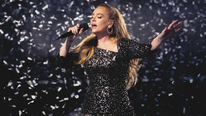 Adele enjoys solo reflection outdoors, expressing quiet self-reliance and confidence