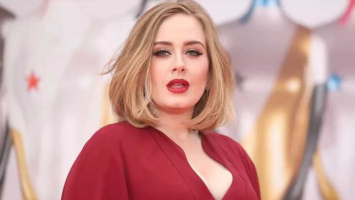 Adele remains observant while greeting fans, showing high vigilance and emotional self-protection