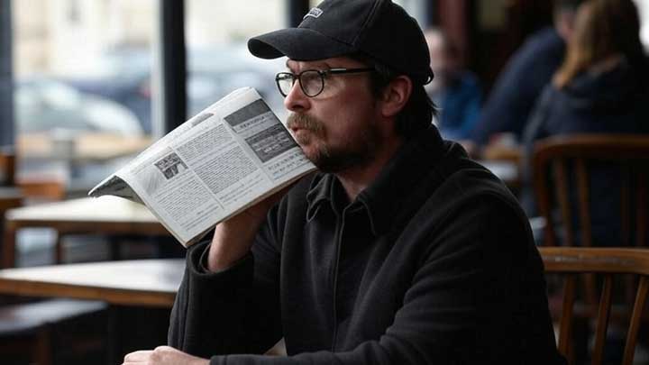 Bale sits incognito at a café, fiercely guarding his privacy and avoiding public attention.