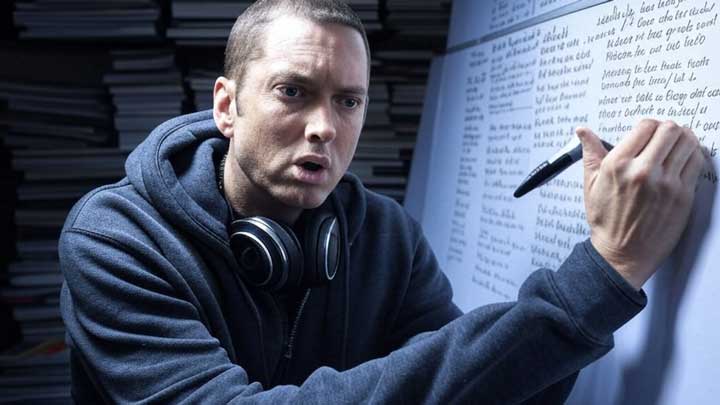 Eminem analyzes rhyme schemes in a chaotic studio, lost in lyrical structure and verbal mastery, reflecting his razor-sharp reasoning and intellect.